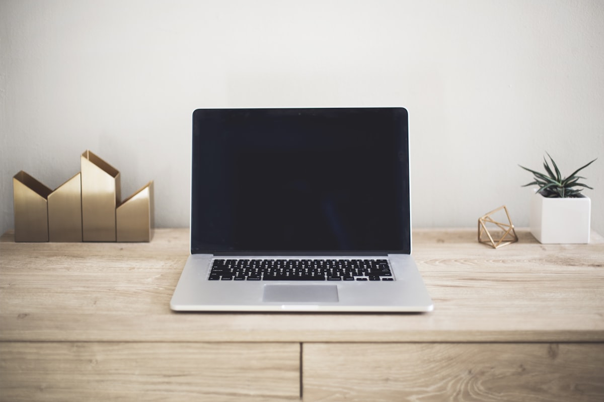 Laptop on a desk, using AI for small business tasks